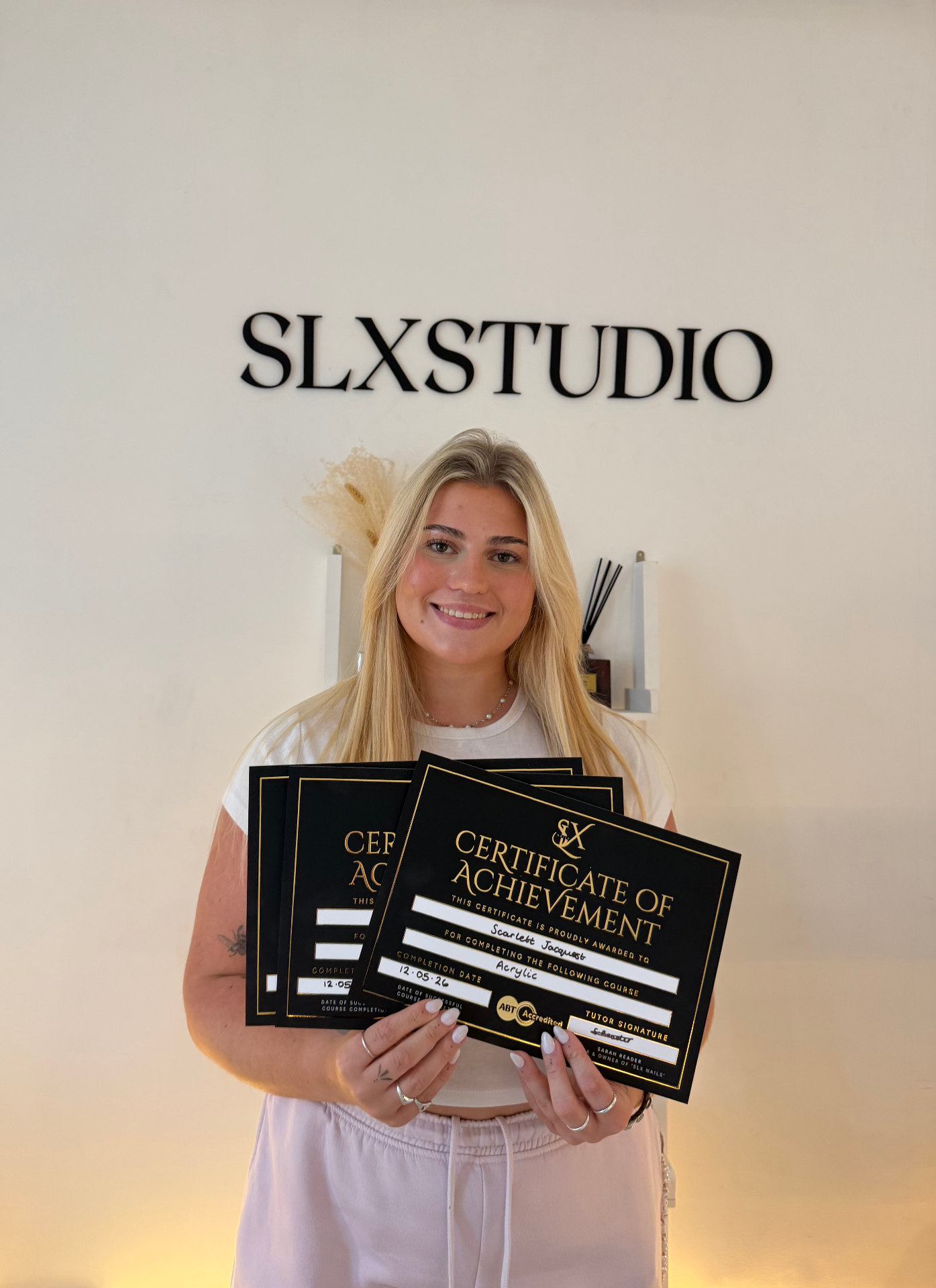 SLX Combined student with certificates at SLX Studio